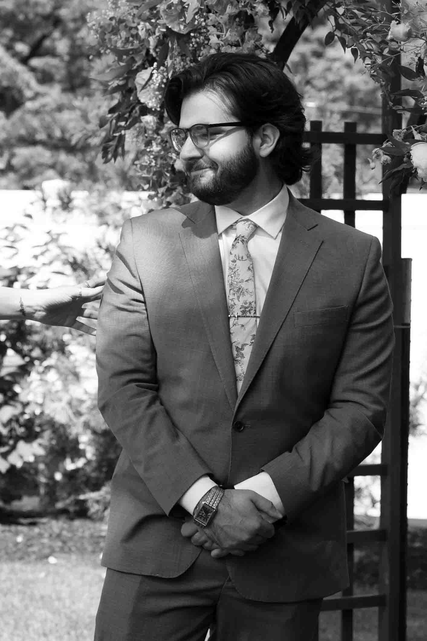 Two people in formal attire share tender moments in a black and white photo series.