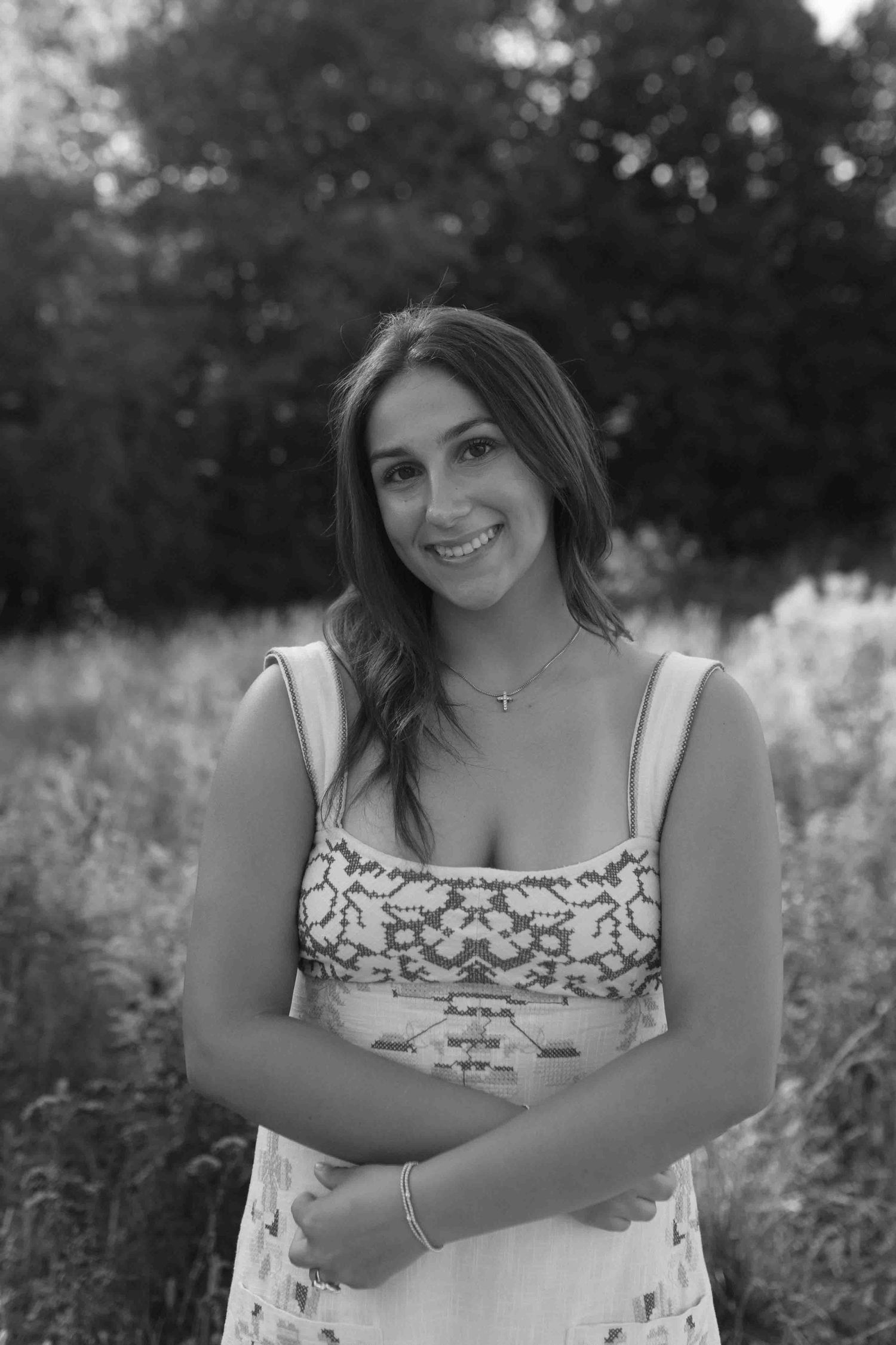 Black and white portrait collection showing relaxed poses in a natural outdoor setting.