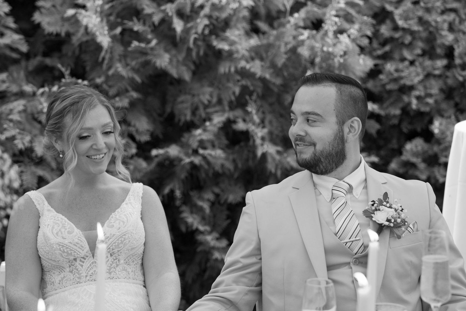 Wedding couple shares joyful moments during their outdoor reception celebration.