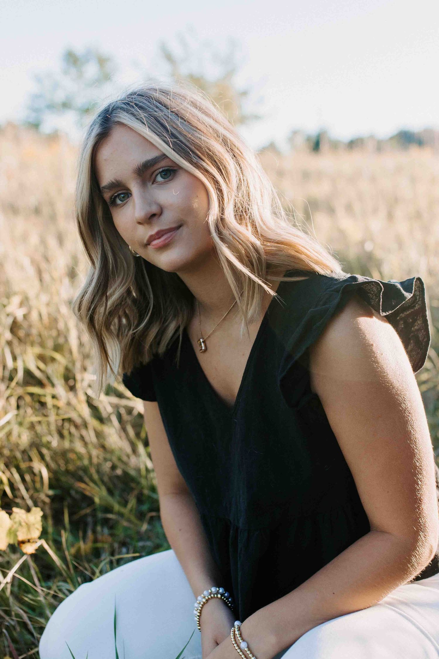 Natural light portrait session in a field during golden hour.