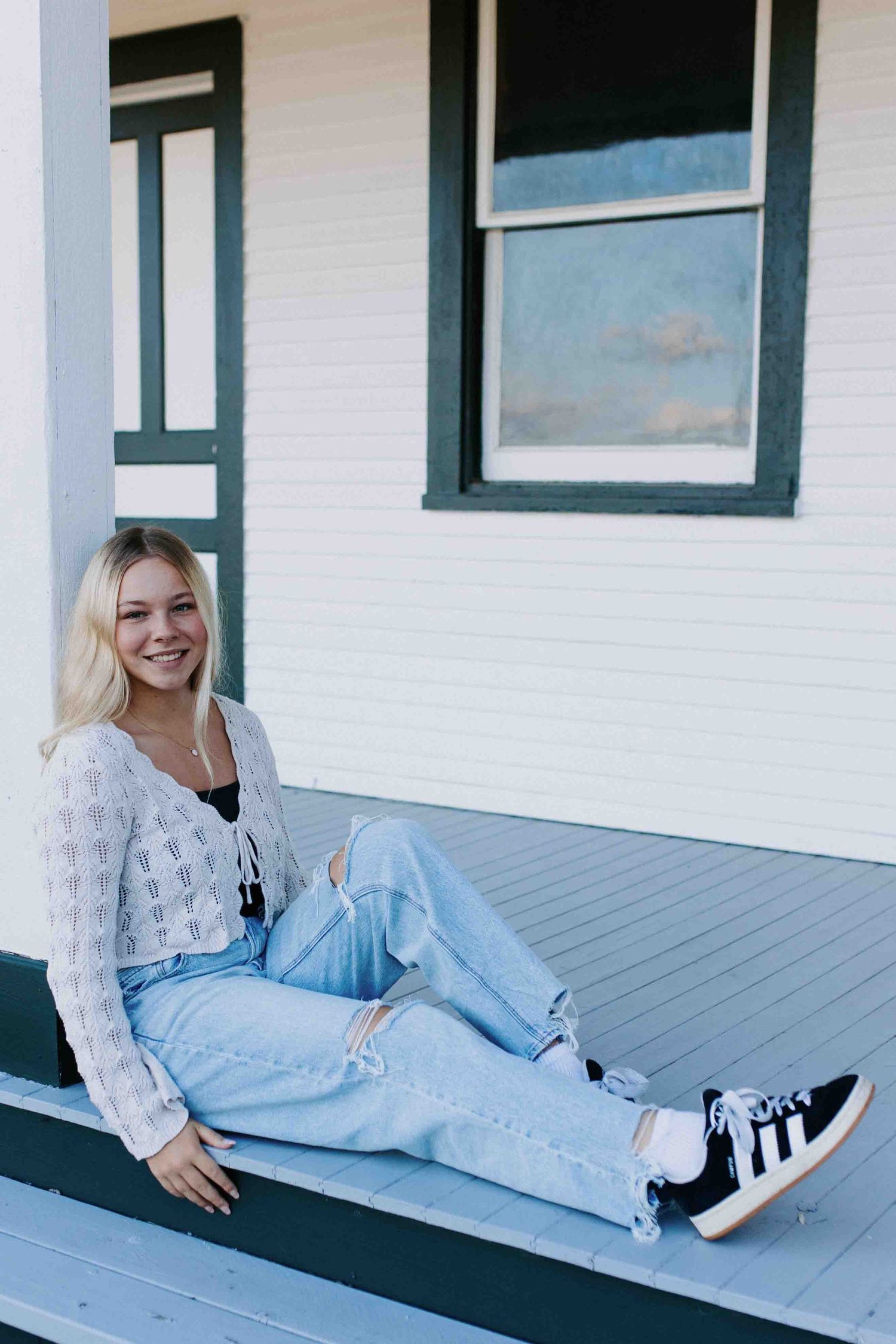 Relaxed shots on a white porch deck showing off a cottagecore-inspired casual outfit.