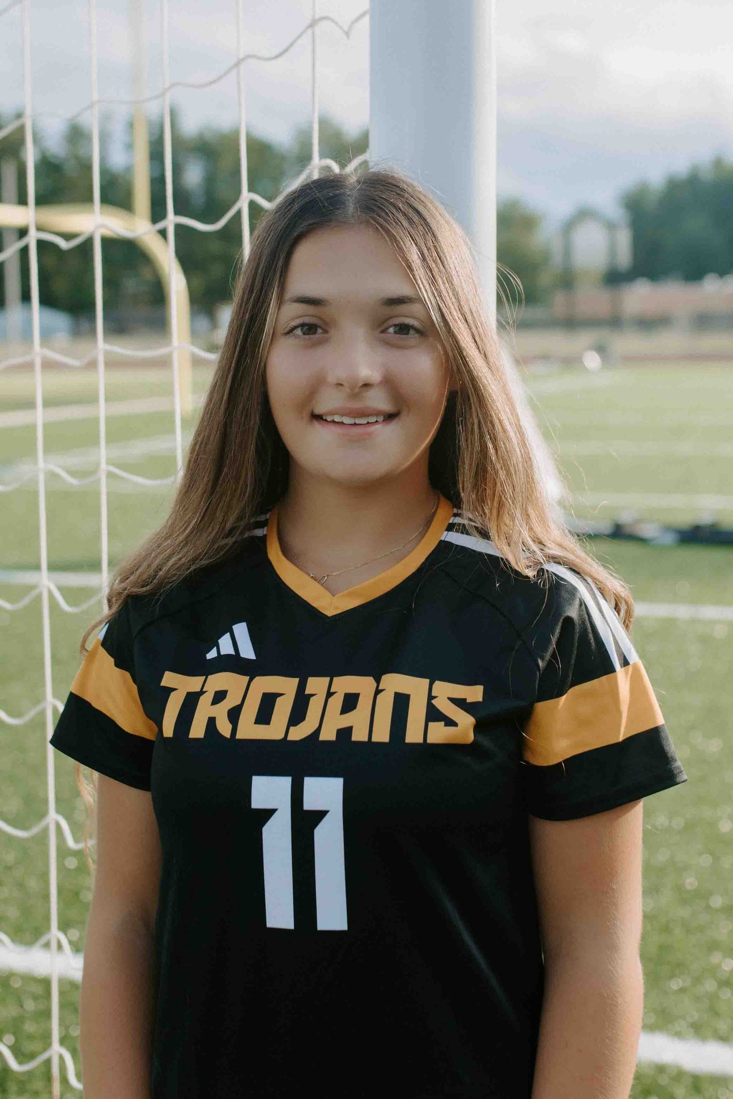 Trojans soccer team uniforms with number 11 jersey displayed.