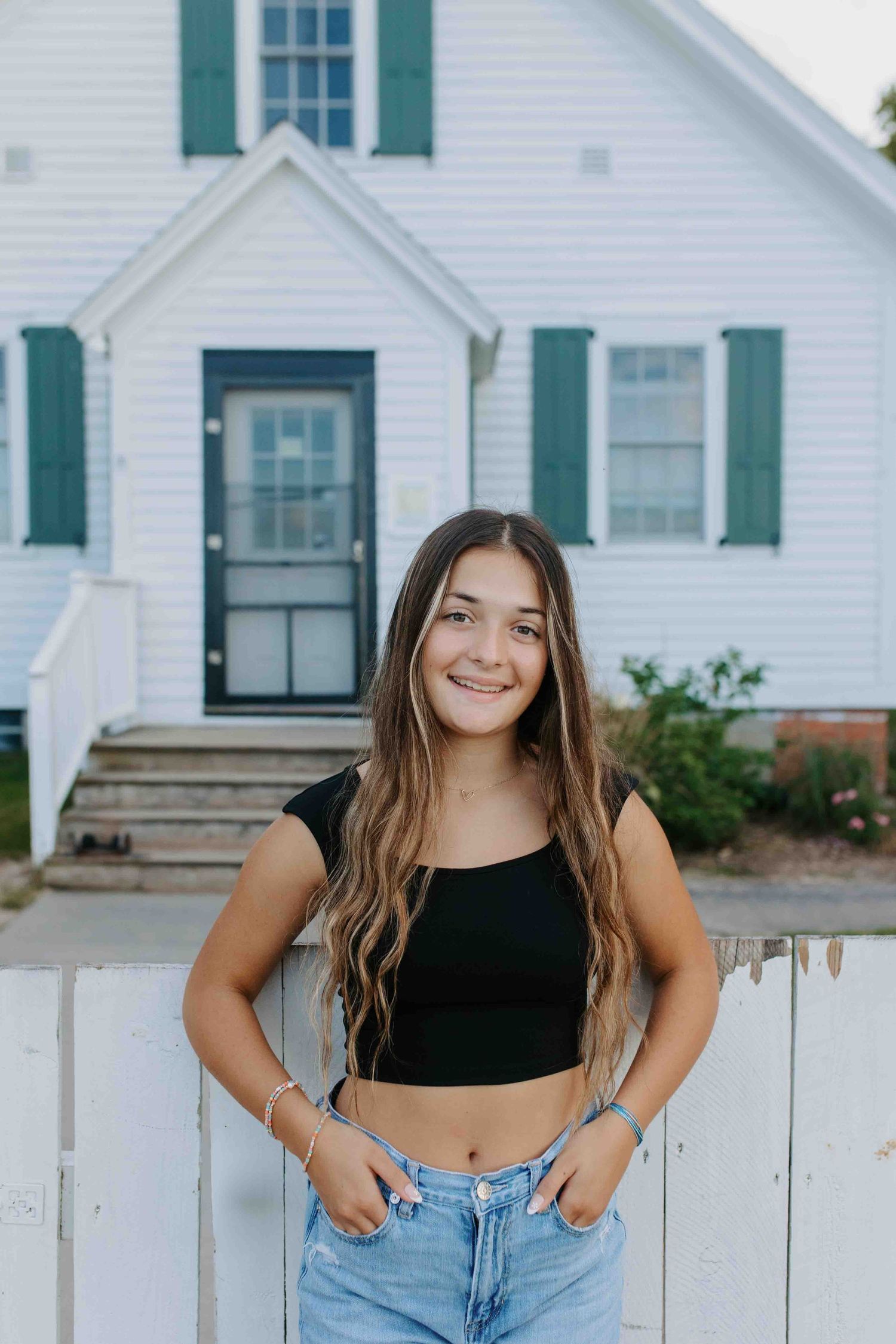 Lifestyle portraits by white farmhouse featuring casual summer outfit.
