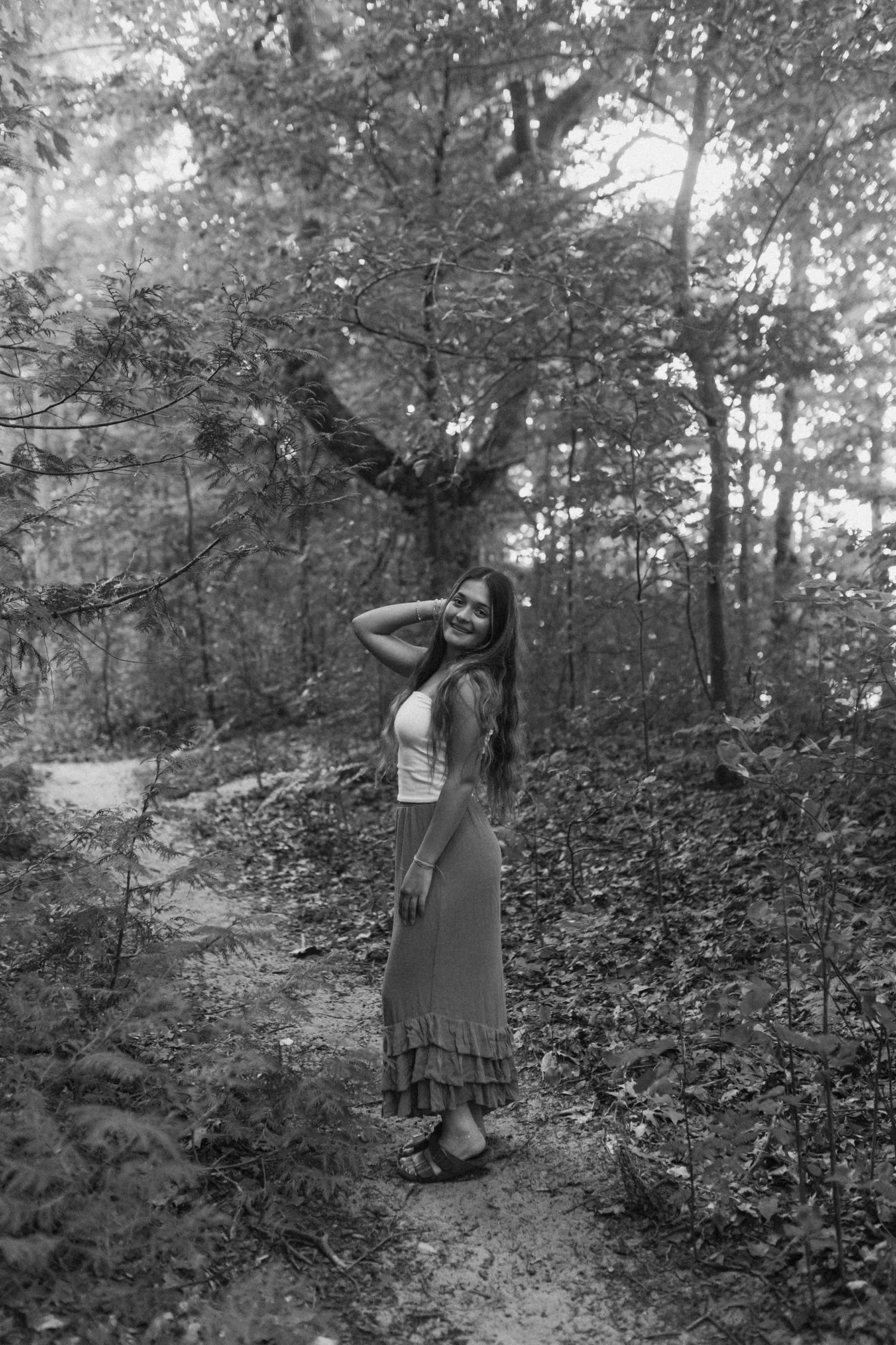 Monochrome woodland photography with artistic poses against natural forest backdrop.