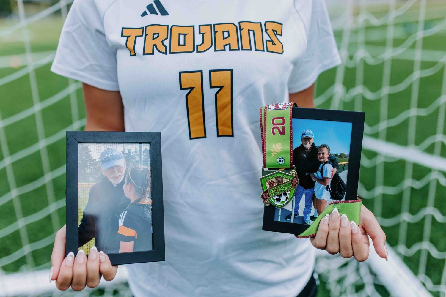 Close up of Trojans soccer uniform with polaroid photos displayed.