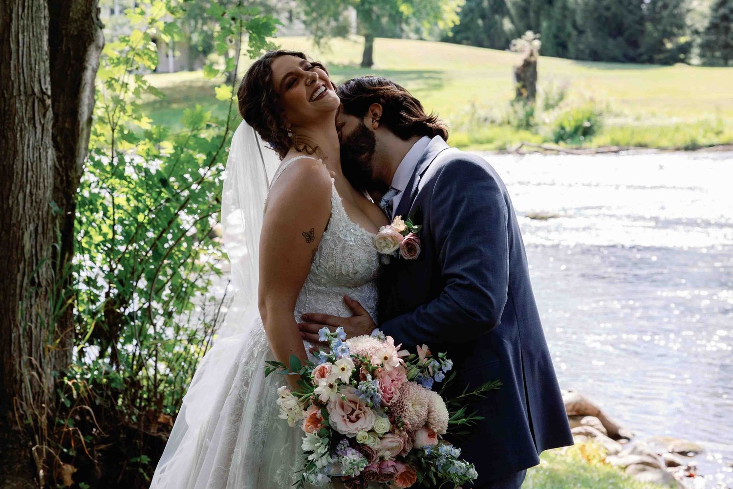 Romantic wedding couple shares intimate moments in a sunlit outdoor garden setting.