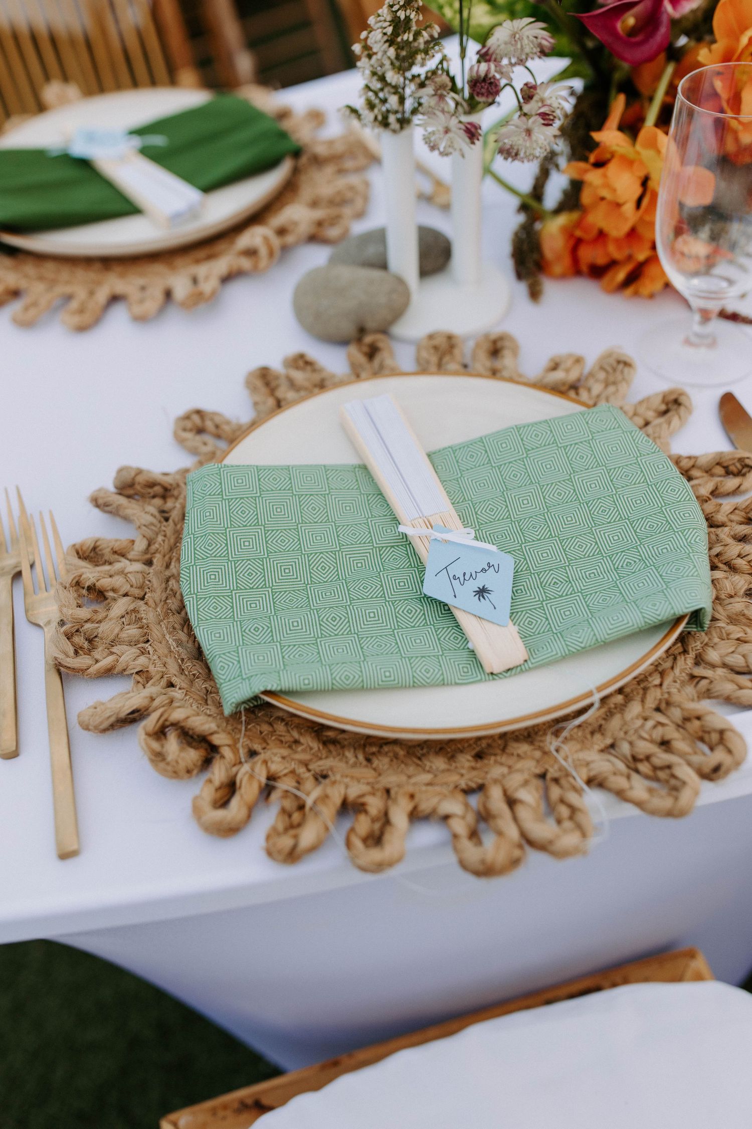 Wedding table settings with mint green placemats and natural rope charger plates.
