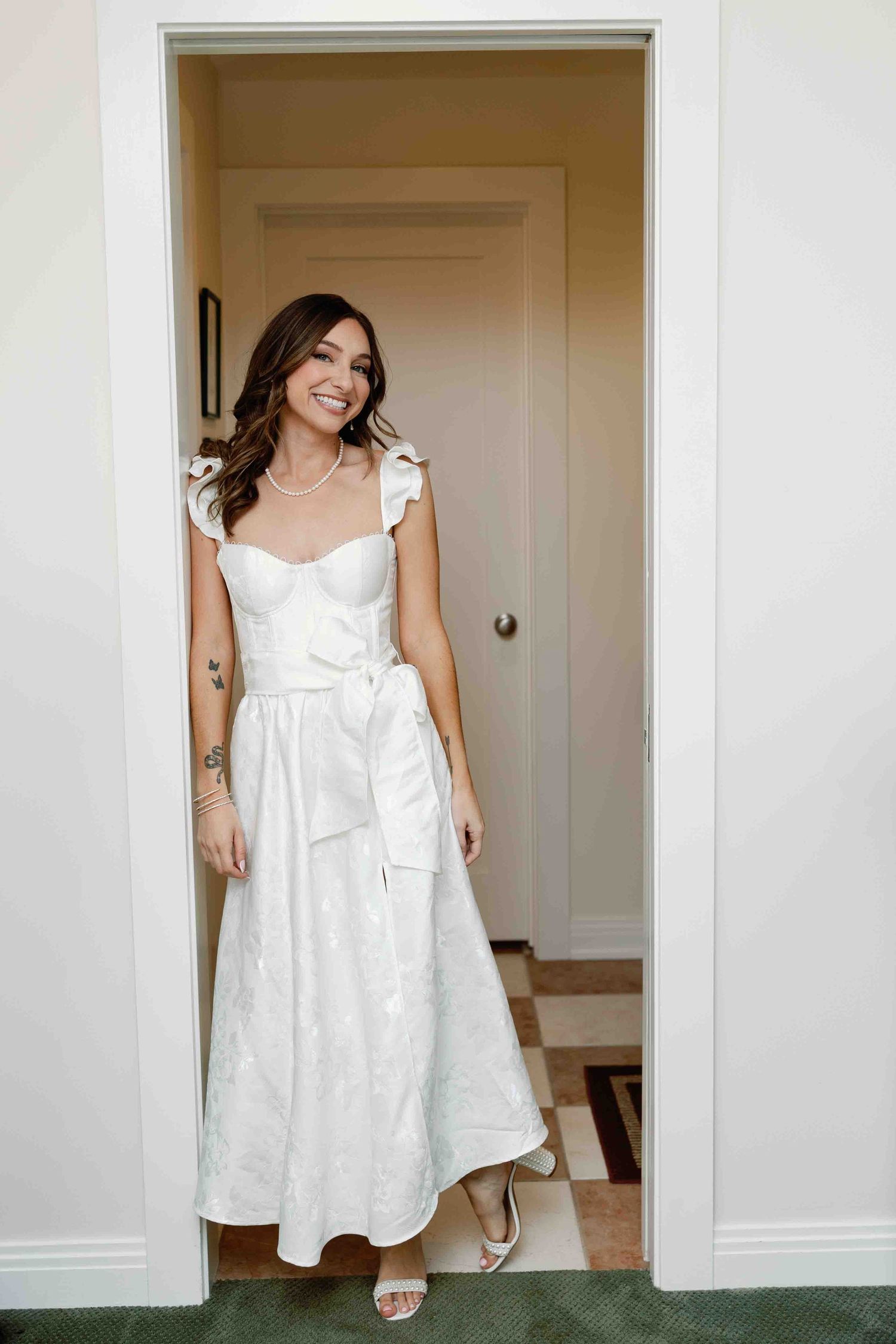 White summer dress shown in multiple angles against minimalist white doorway.