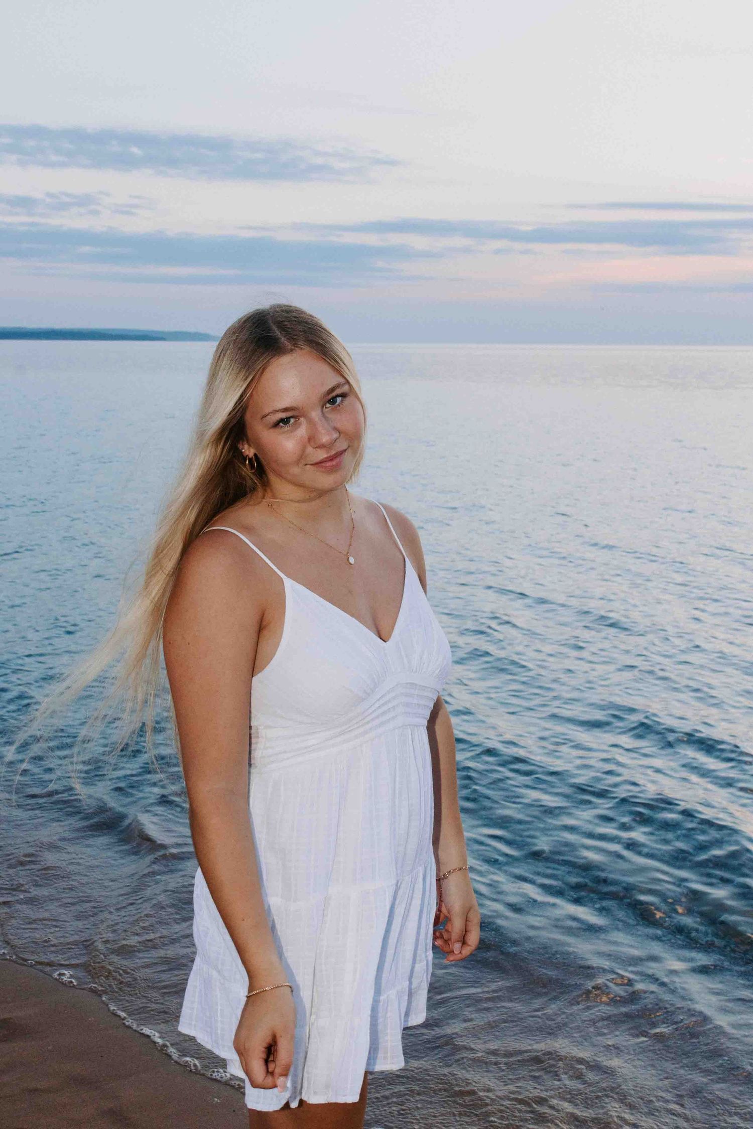 White summer dress photoshoot by the ocean during golden hour.