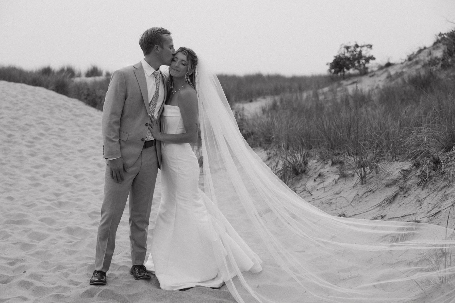 Wedding photography sequence shows romantic moments between couple on coastal dunes.