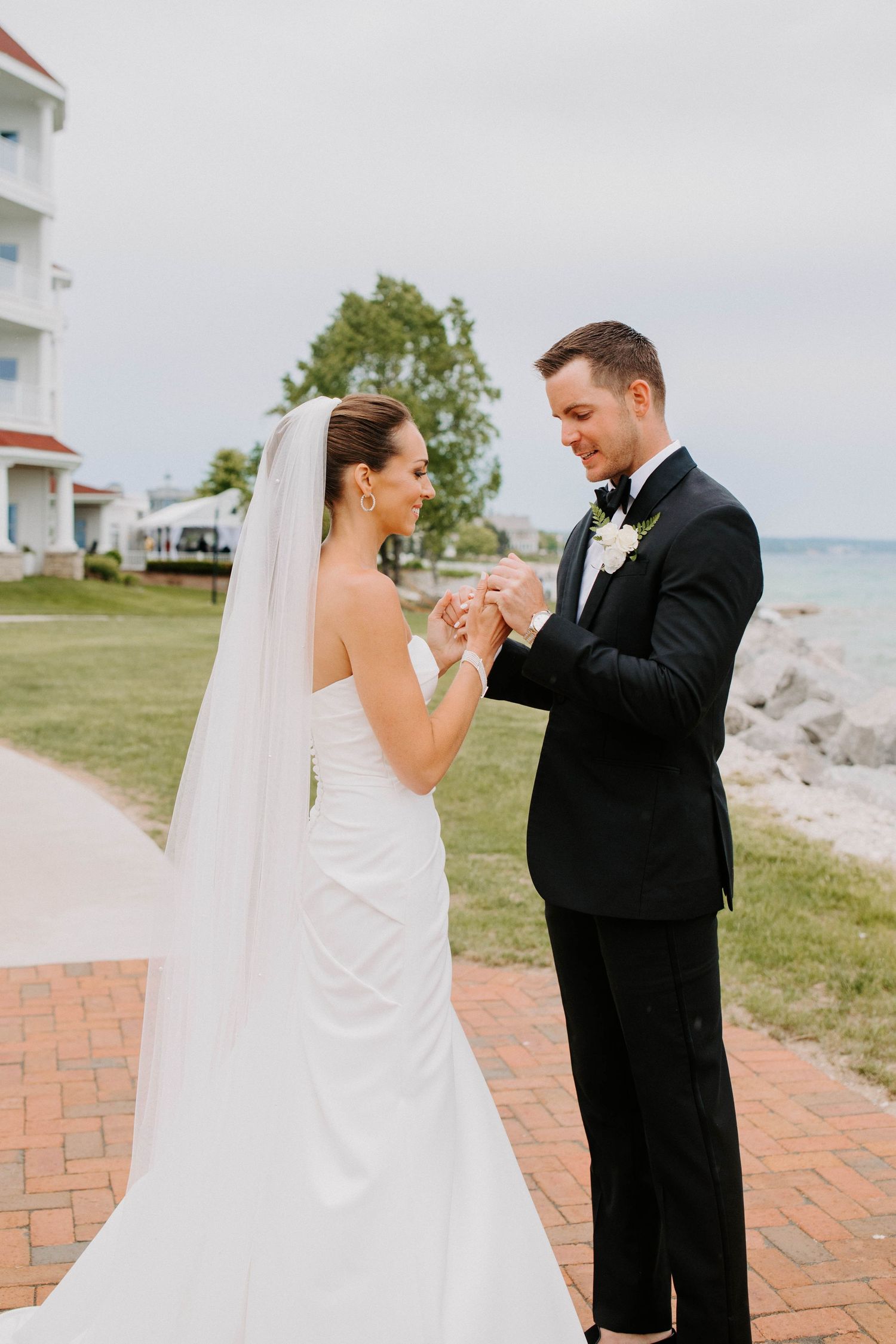 A bride and groom share an intimate moment during their first look on their wedding day by the ocean.