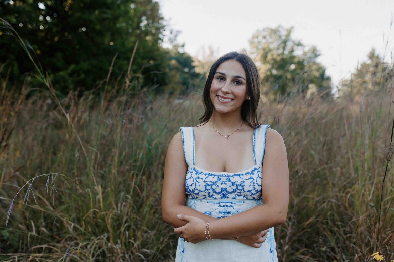Outdoor lifestyle portrait session with natural lighting and summer field backdrop.