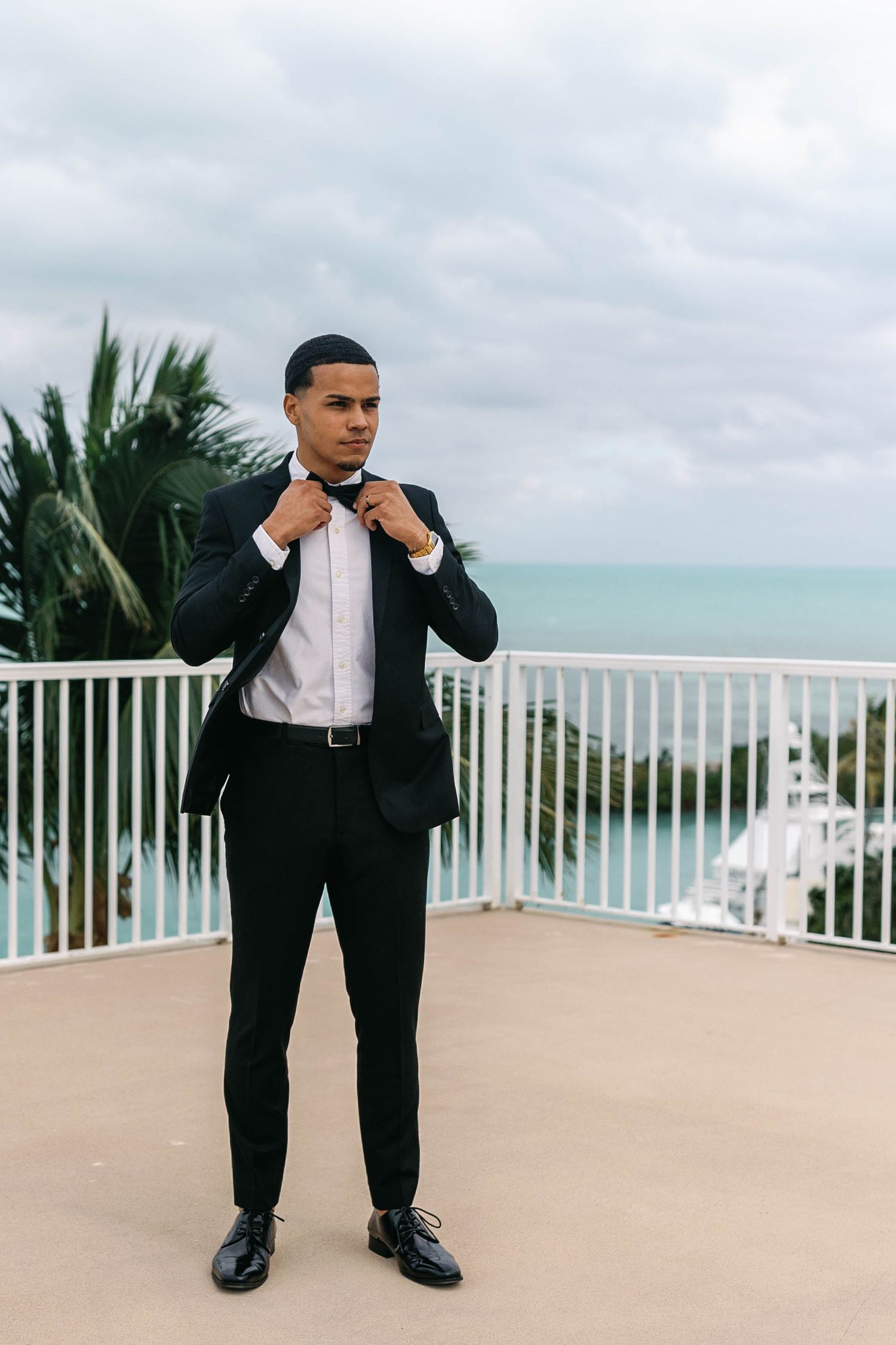 Wedding photography sequence on a beachfront balcony with ocean views.
