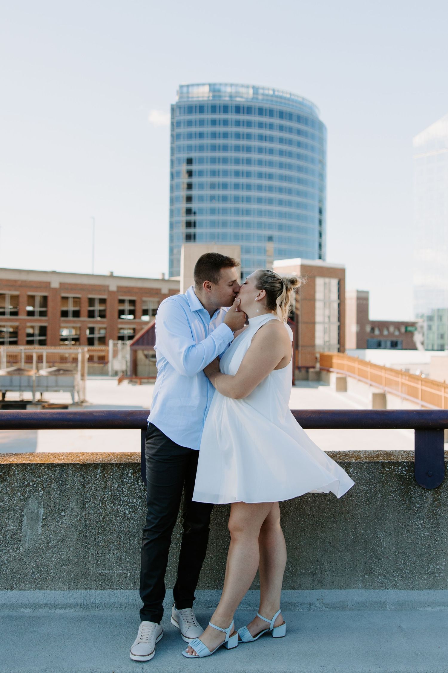 Romantic rooftop photoshoot with city skyline in the background.