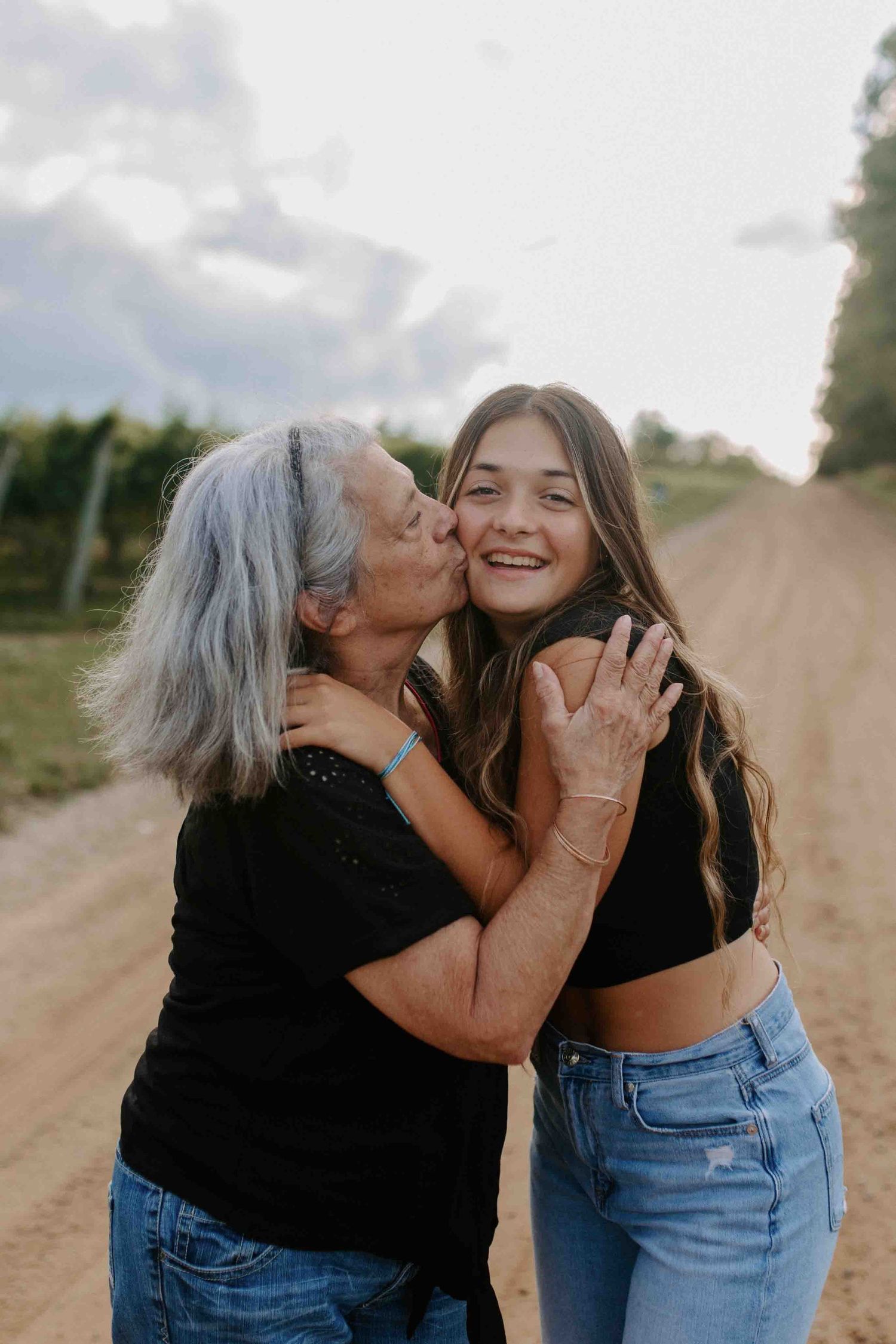 Affectionate outdoor portrait session showing genuine emotion on a rural path.