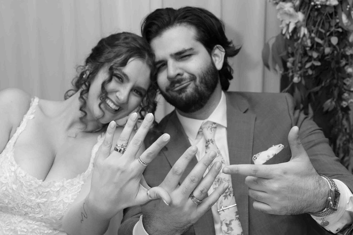 Black and white photo sequence of a couple sharing joyful moments at their wedding reception.