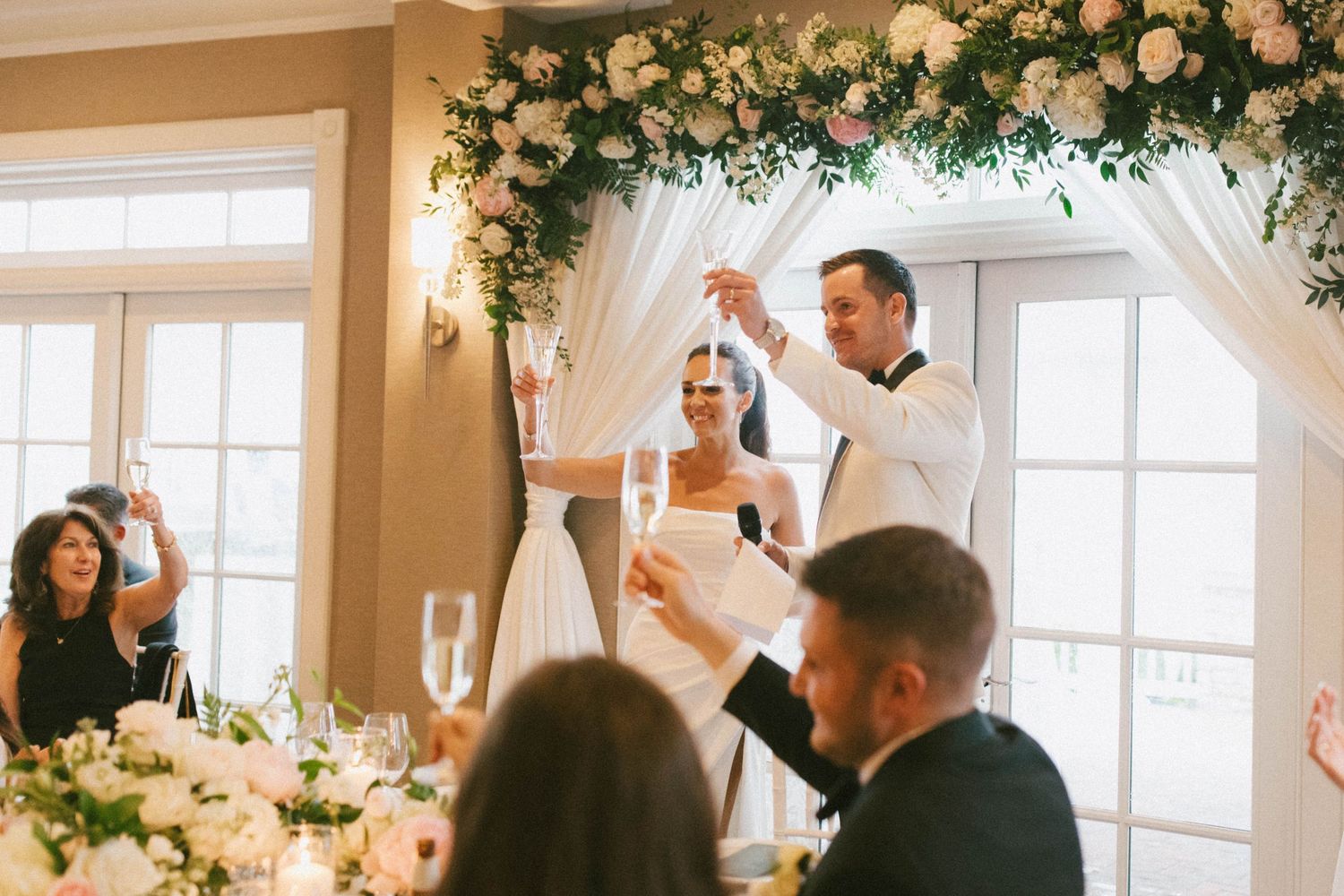 Wedding ceremony space adorned with lush floral arrangements and natural lighting.