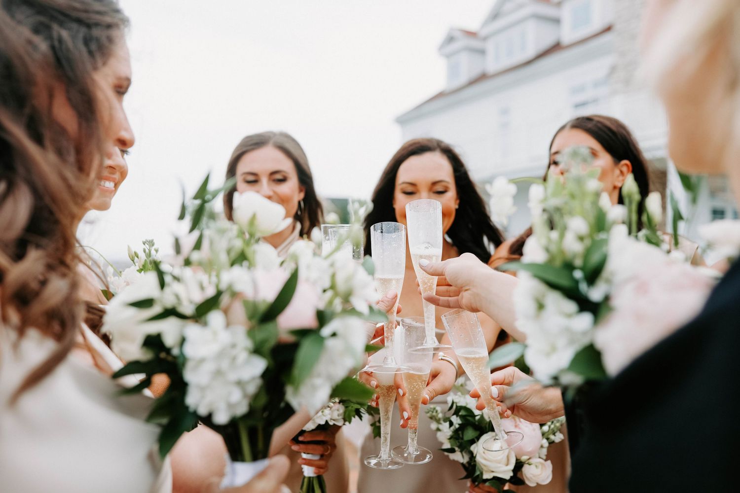 Wedding party toasting with champagne glasses at an elegant celebration.