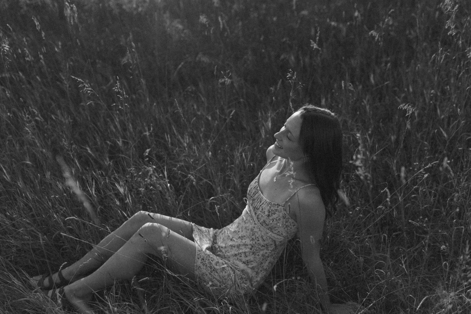 Black and white portrait session in tall grass field.