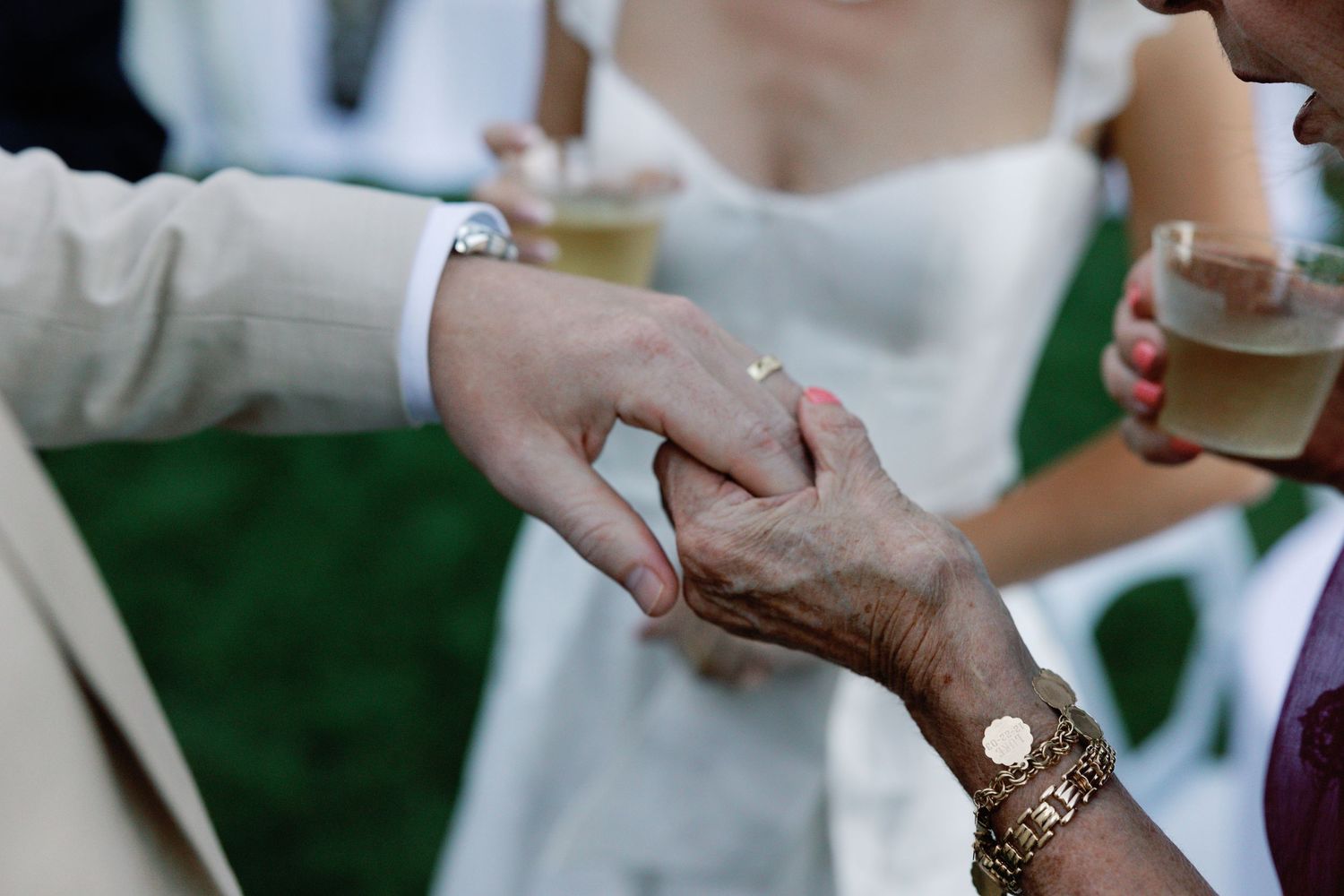 Close-up details of hands and embraces during wedding celebration moments.