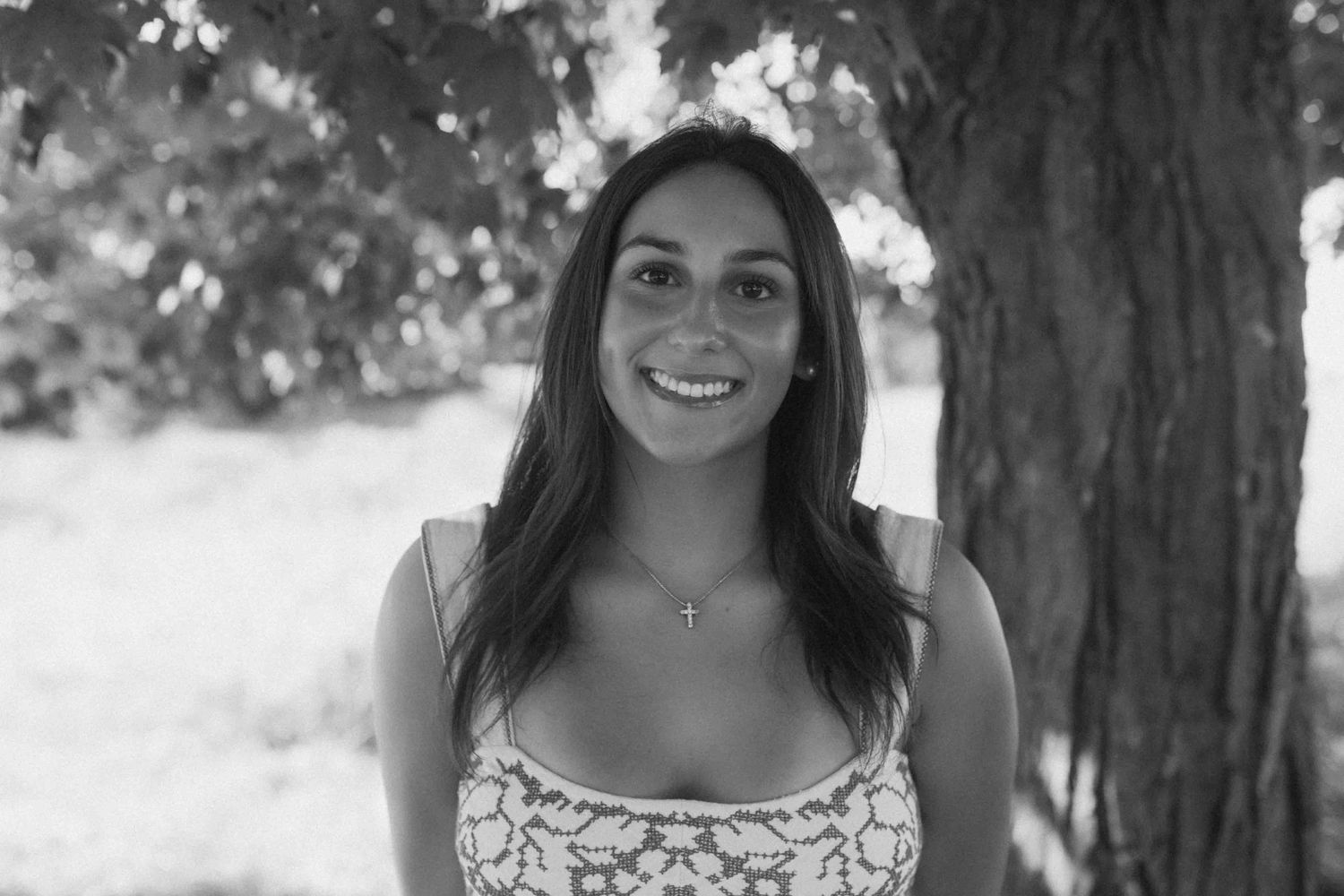 Black and white portrait series showing natural expressions under trees.