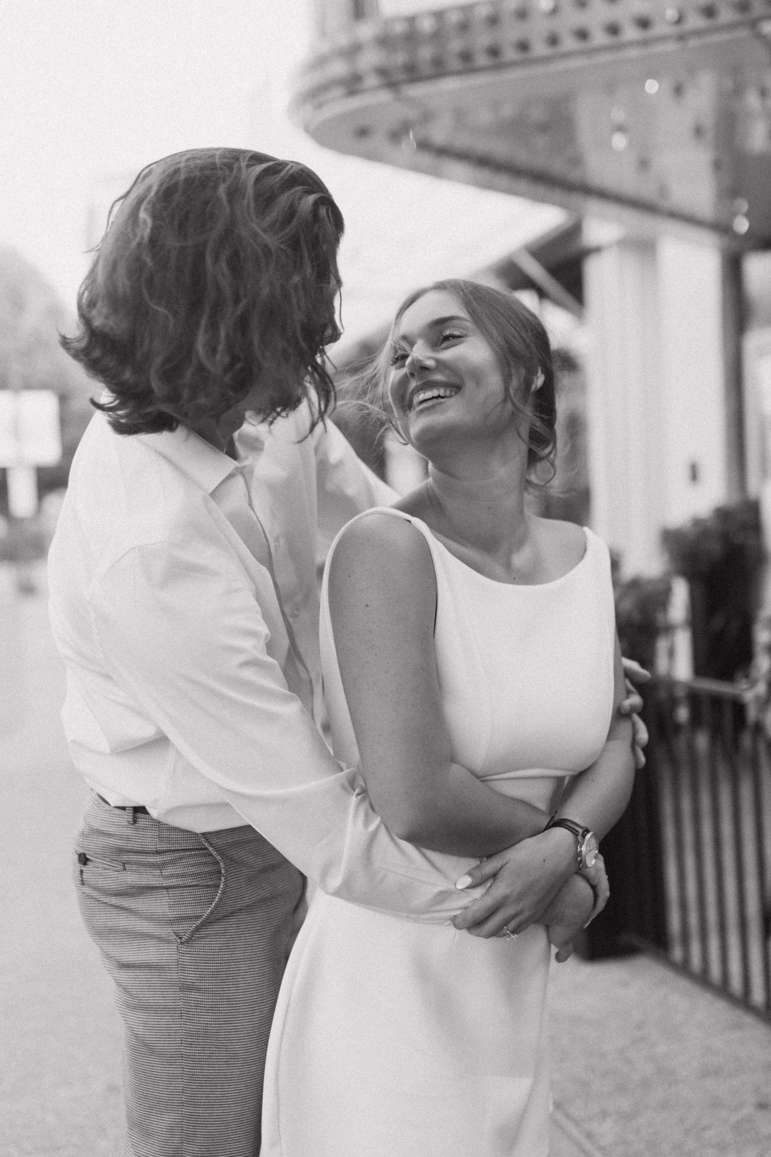 Black and white photo series of a romantic embrace outdoors.