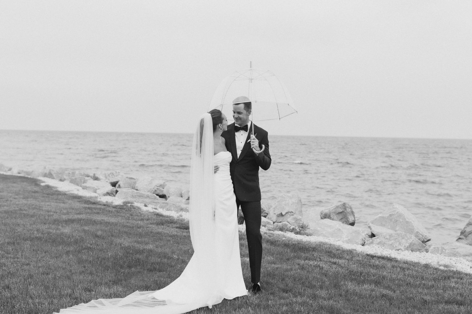 Black and white romantic wedding portraits by the ocean.