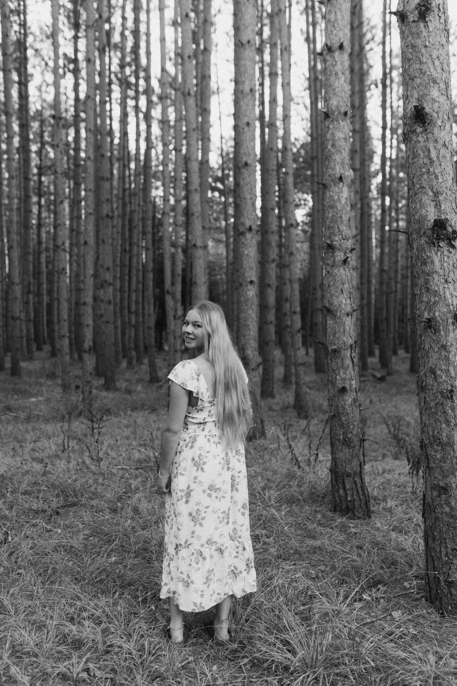 Black and white back view portrait in a serene forest setting.
