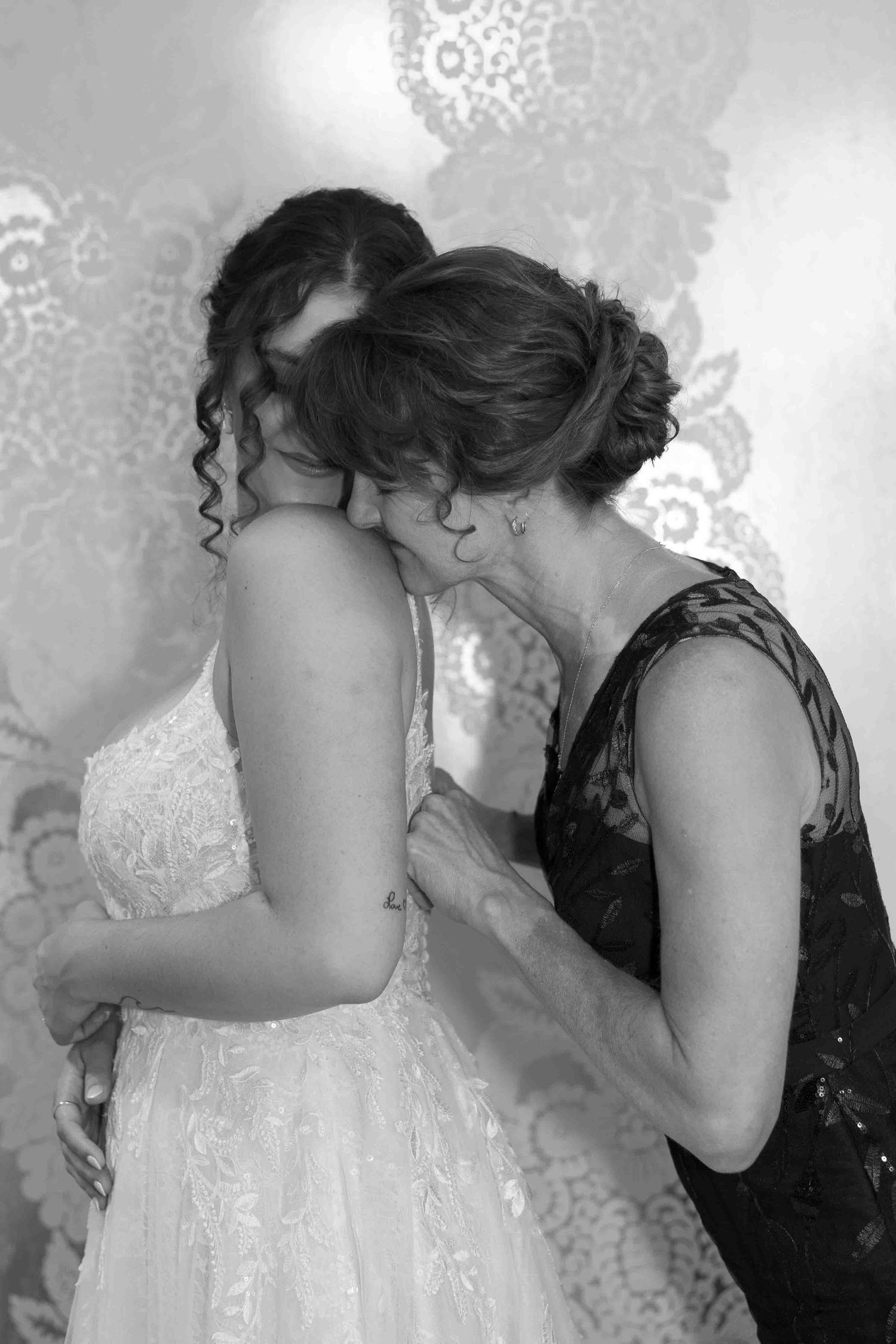 Close up of formal dress being adjusted with delicate attention to detail.
