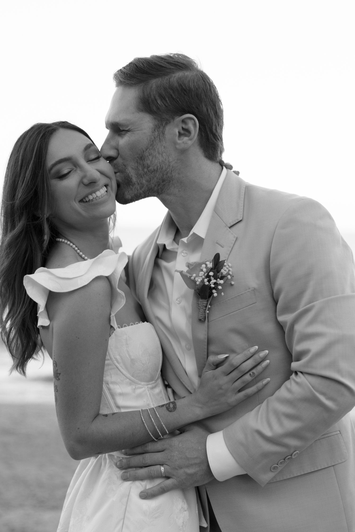 Black and white photos show a couple sharing intimate moments during their wedding photoshoot.