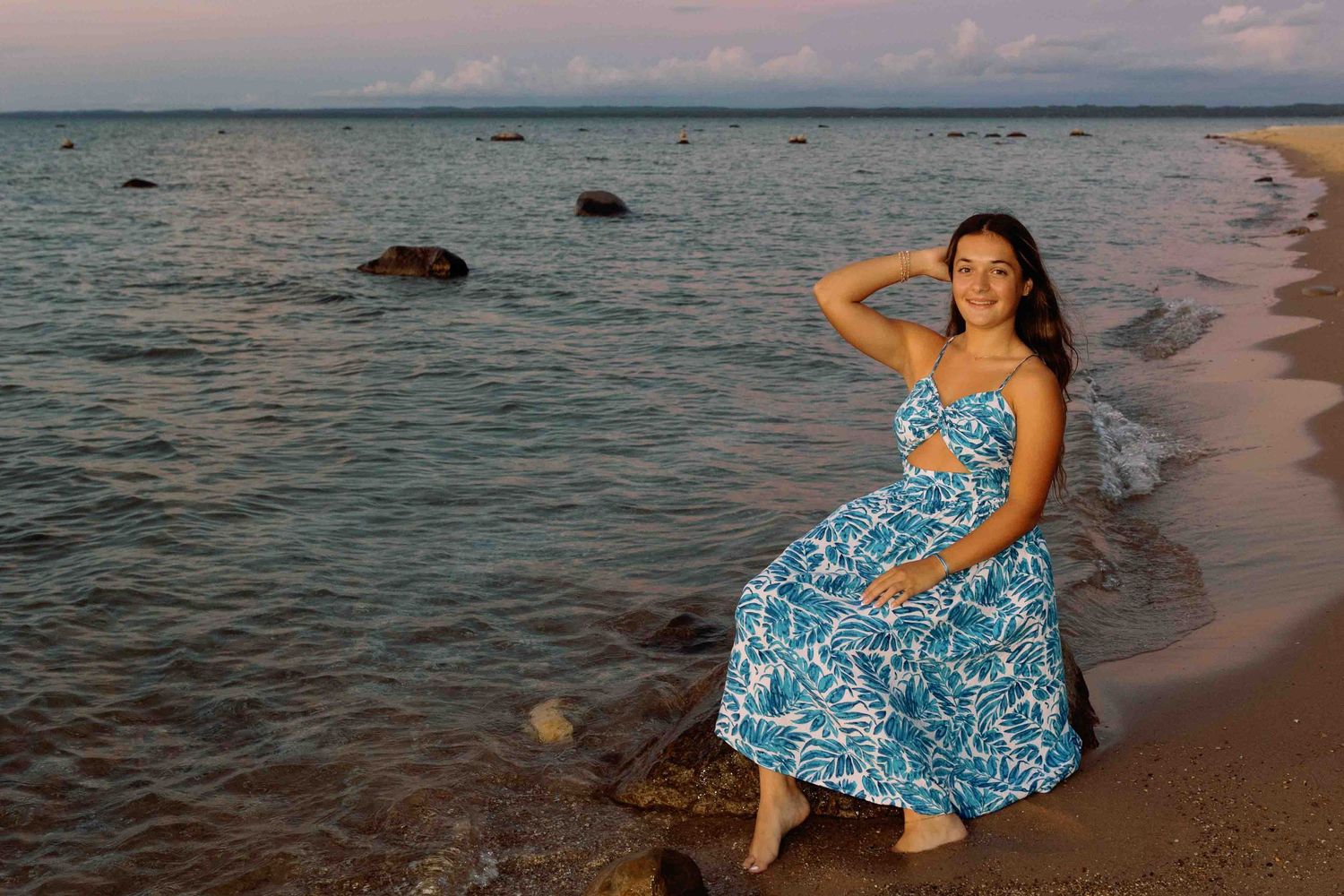 Beach photography session during golden hour with waves crashing on the shore.