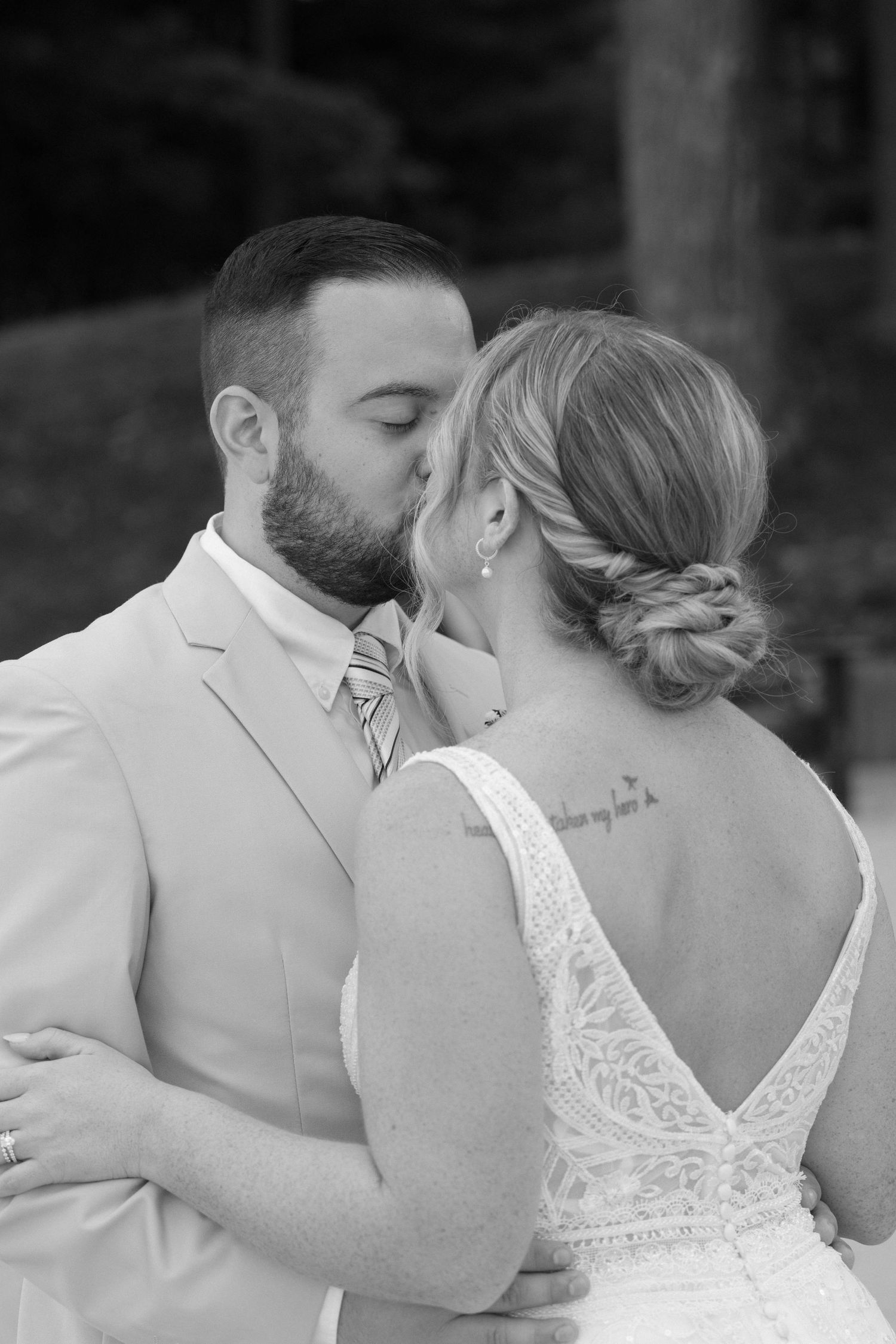 Romantic black and white close-up shots of a couple embracing during their wedding.