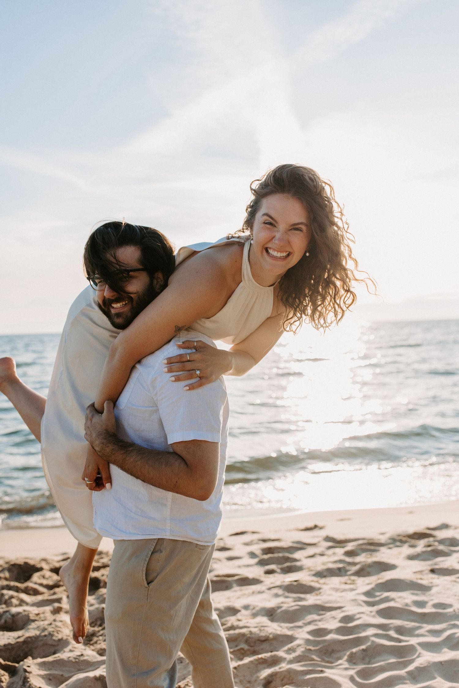 Playful couple enjoying a sunny day at the beach.