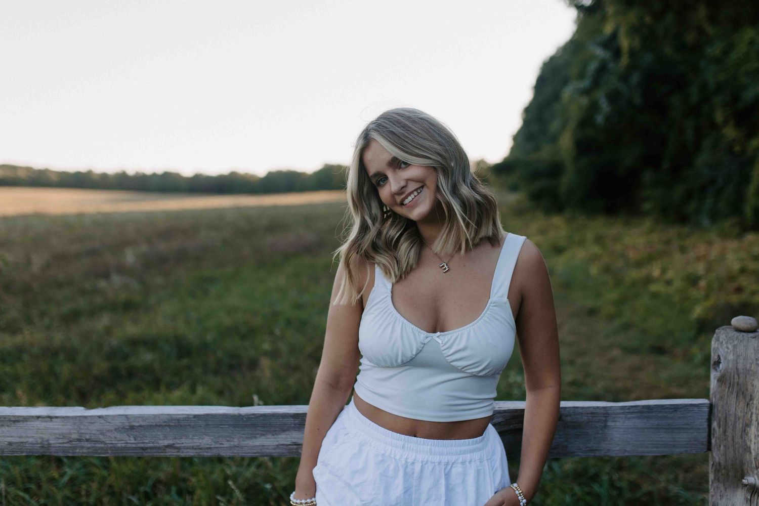 Candid outdoor photography session at sunset in a rural setting.