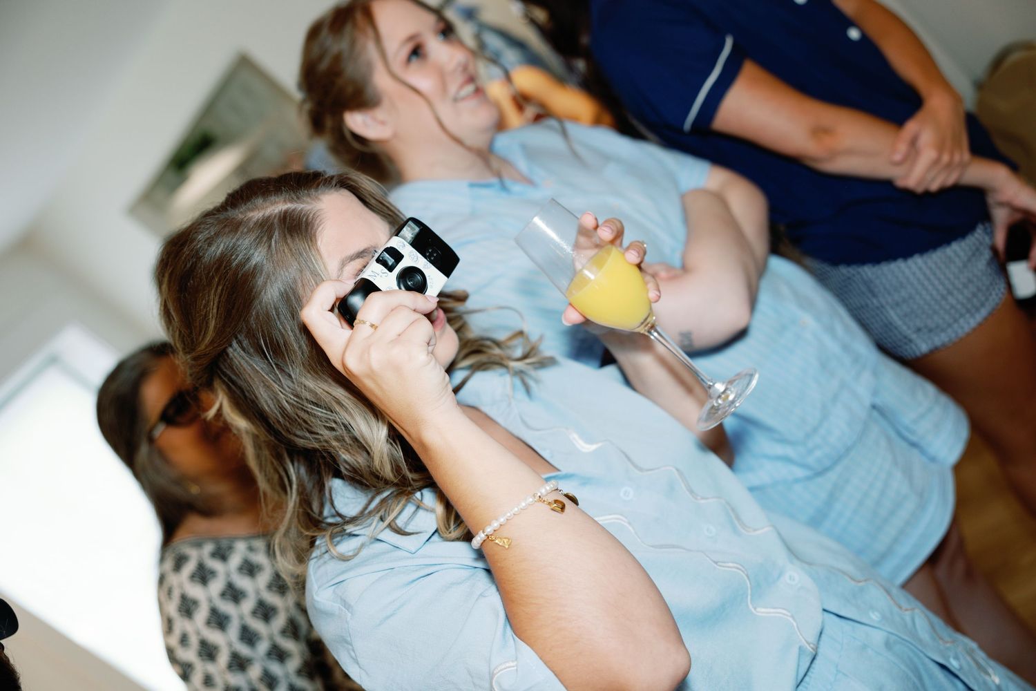 Candid moments shared during wedding day preparations in soft lighting.