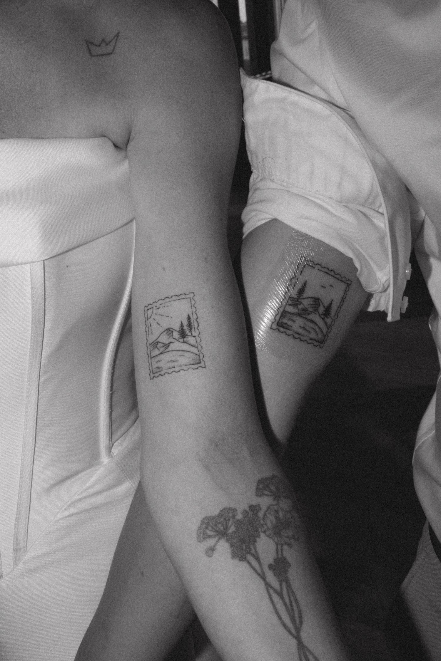 Close-up black and white photo showing tattoo details on wedding day.