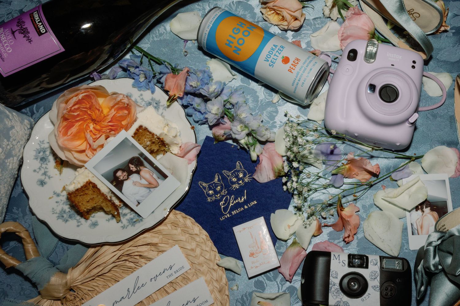 Vintage-style polaroid photos and memorabilia scattered on a blue surface.