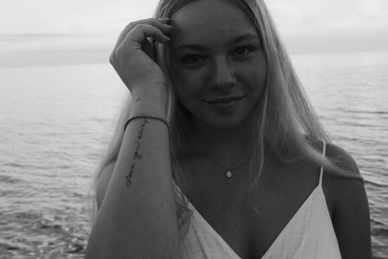 Monochrome portraits showing expressive poses during a beach photography session.