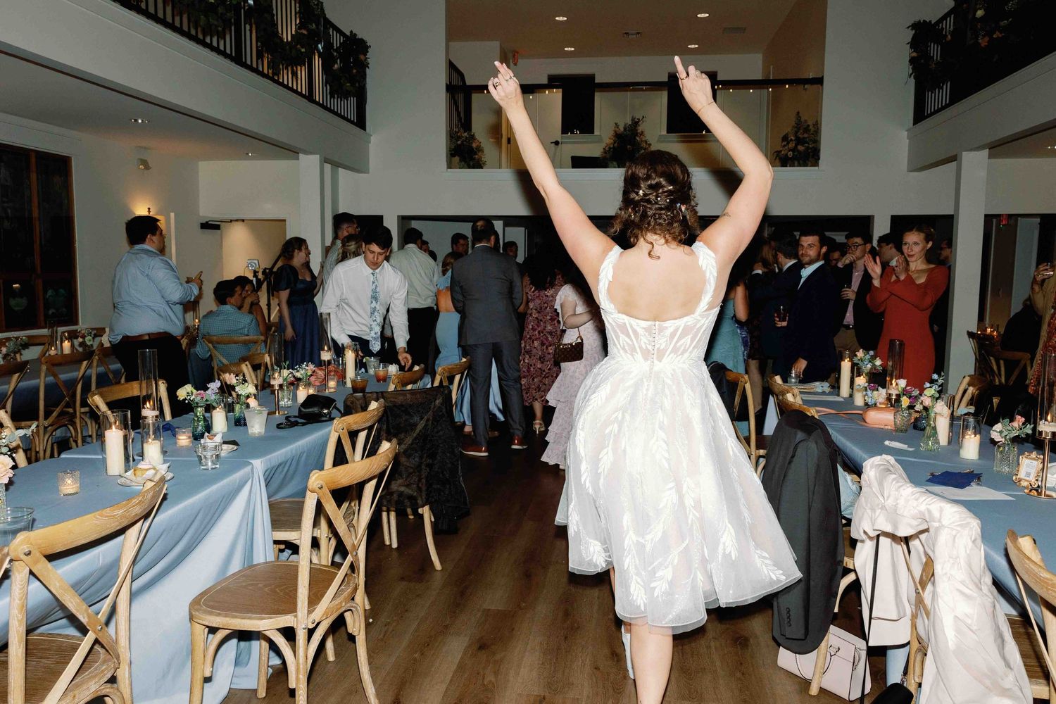 Wedding reception dance party with guests in formal attire enjoying themselves on a dance floor.