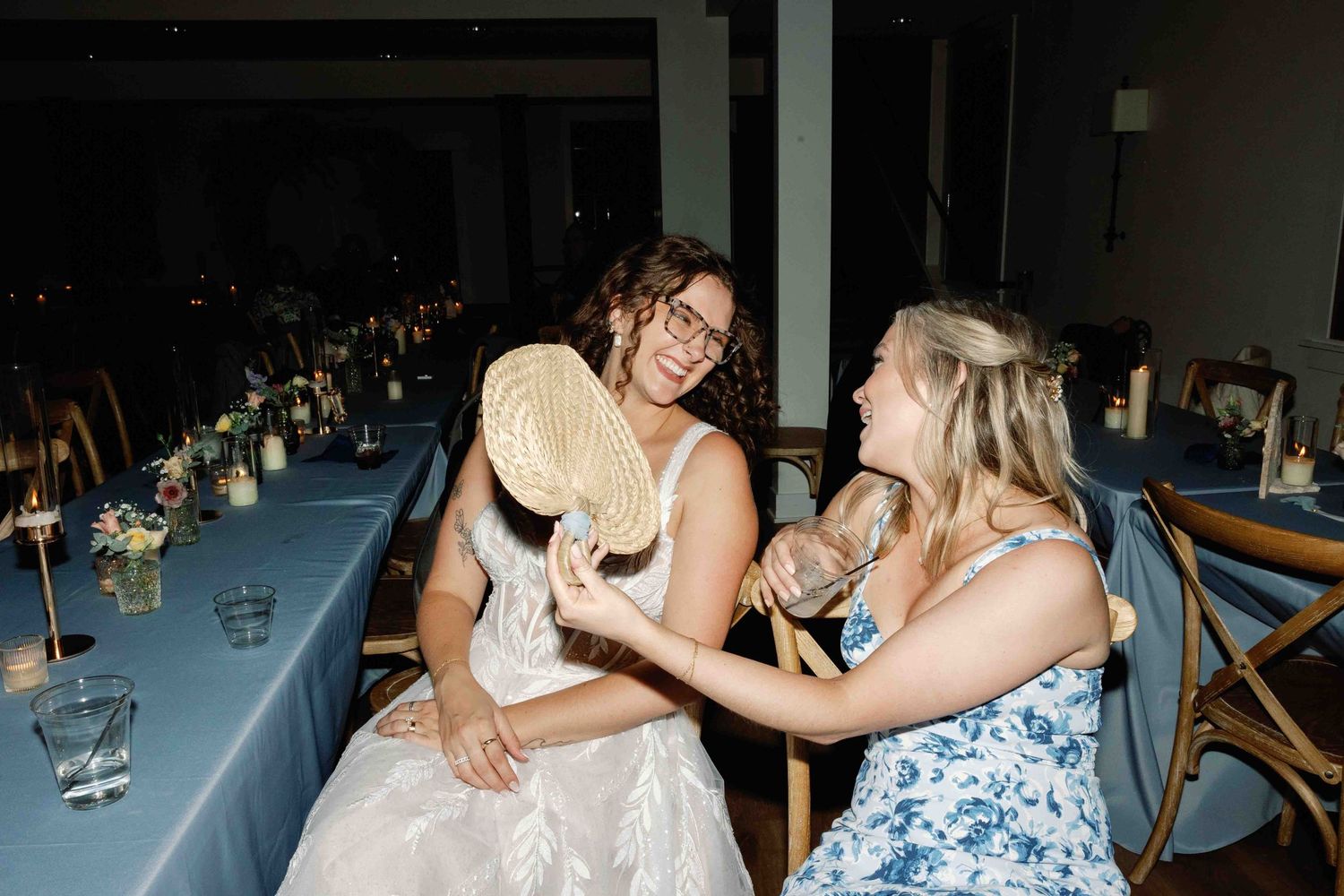 Wedding guests dancing and celebrating at an indoor reception venue.