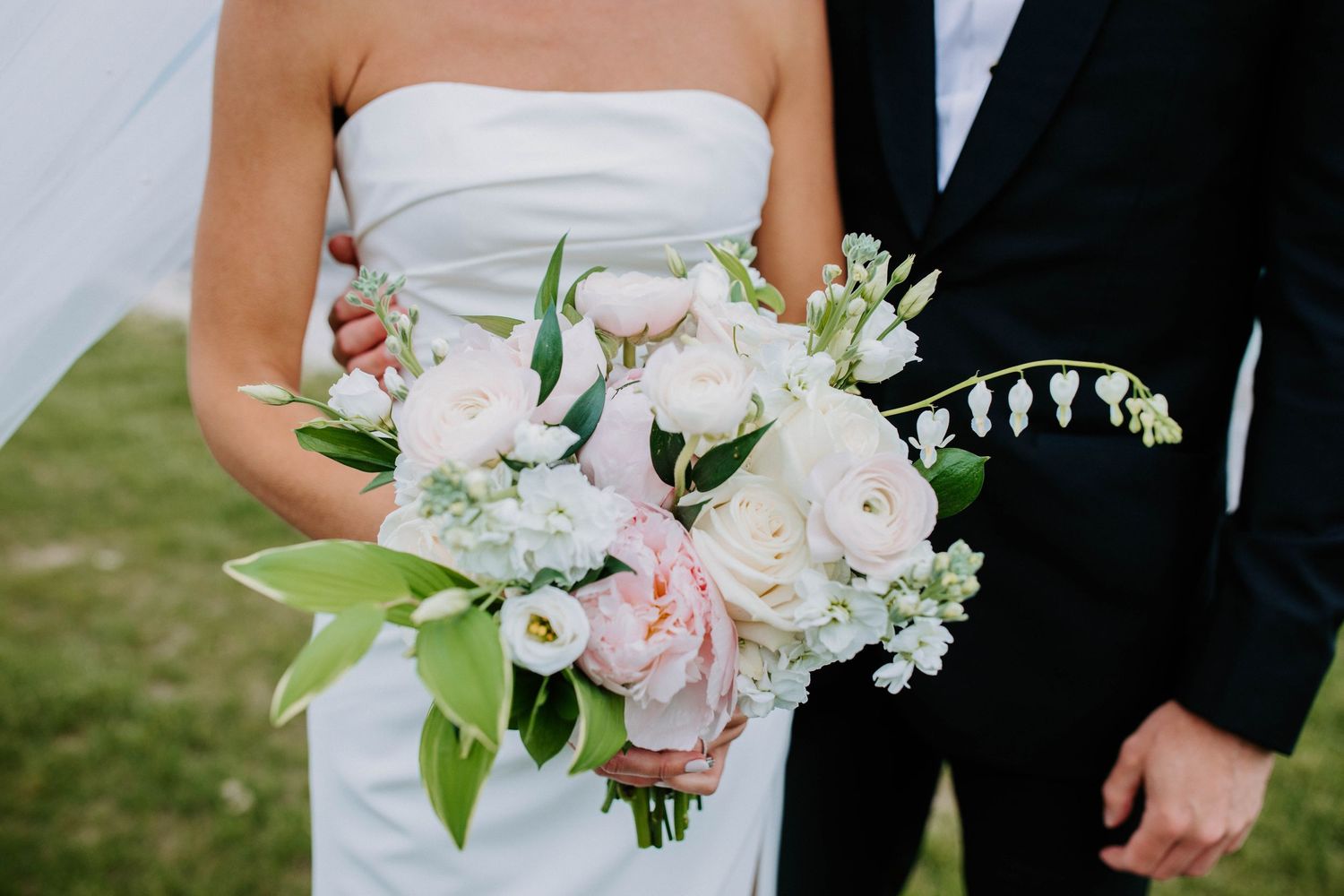 Wedding bouquet details featuring white roses and delicate floral arrangements.