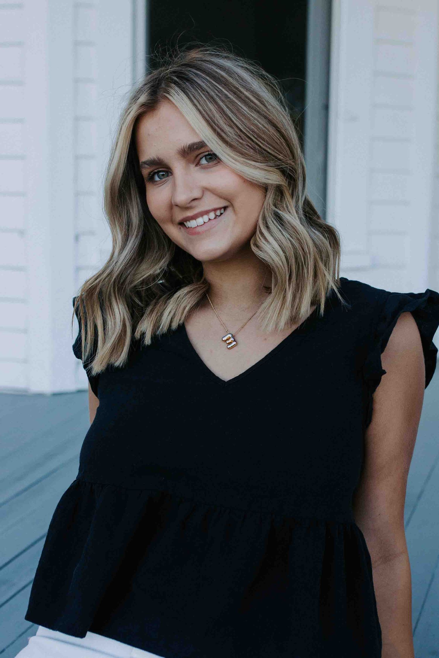Portrait series showing a casual black top against a white background.