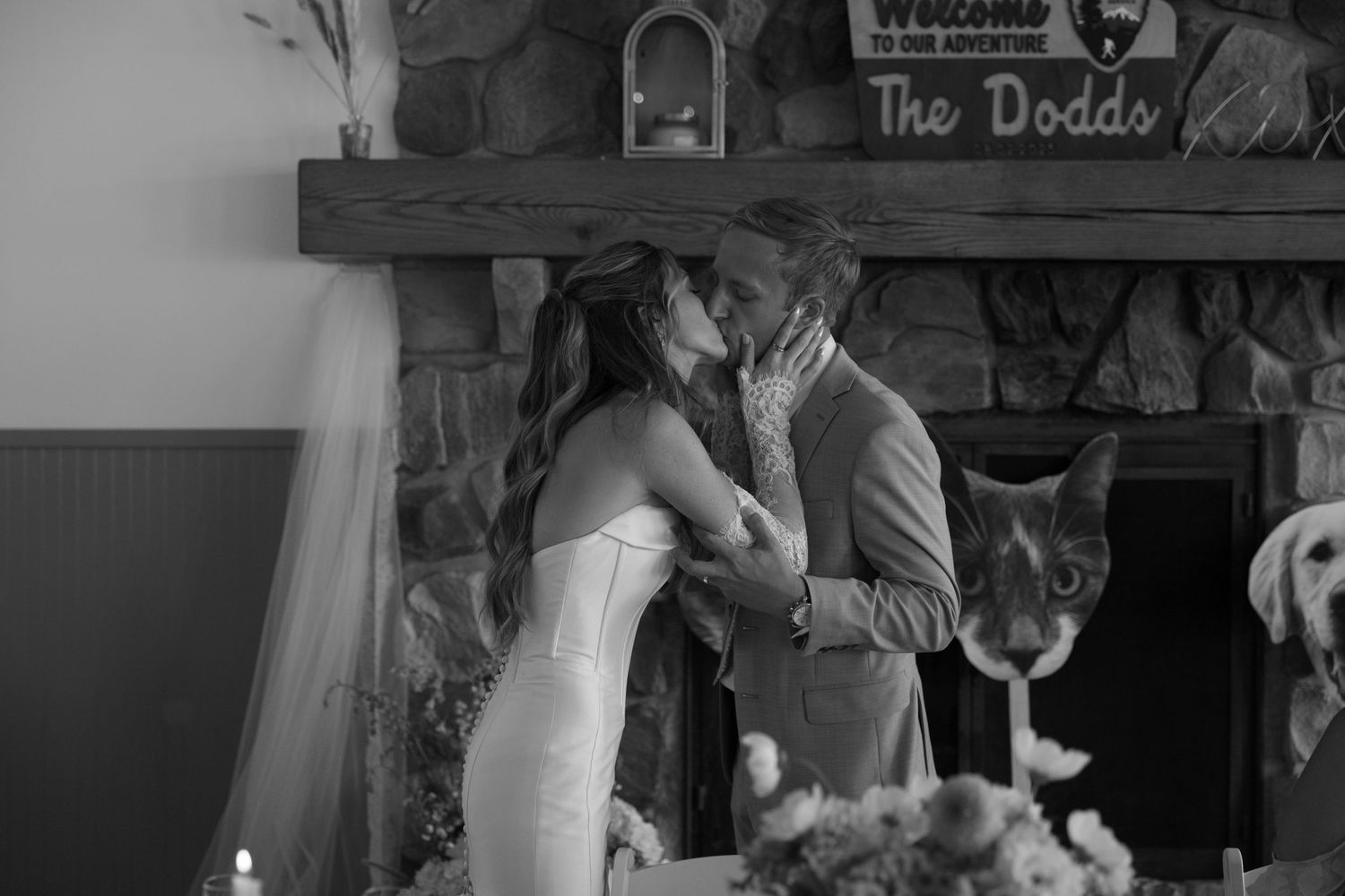 Wedding ceremony taking place in front of a rustic stone fireplace.