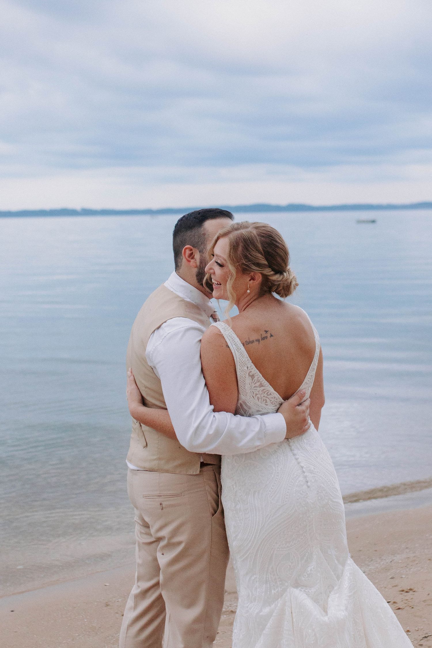 Newlyweds share tender moments during their beach wedding photoshoot.