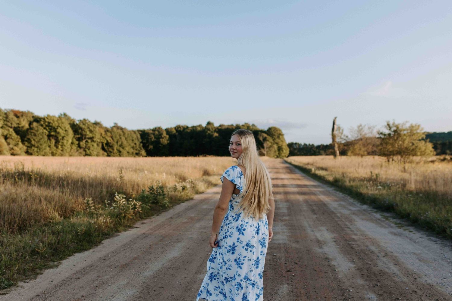 Strolling down a countryside path in late afternoon light.