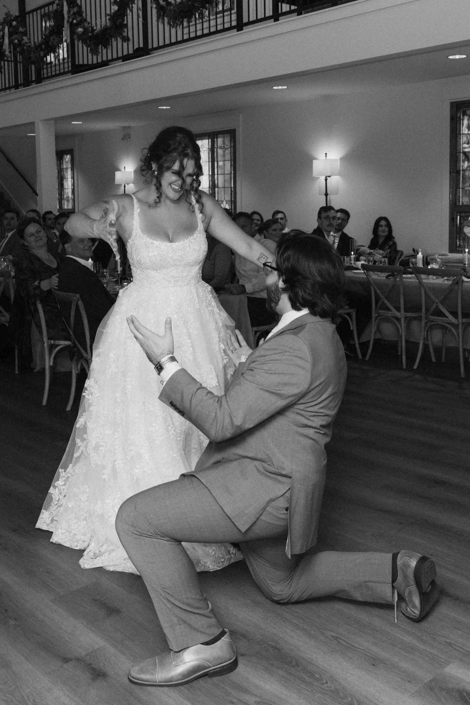 Black and white photo sequence of a playful wedding dance move on a wooden floor.