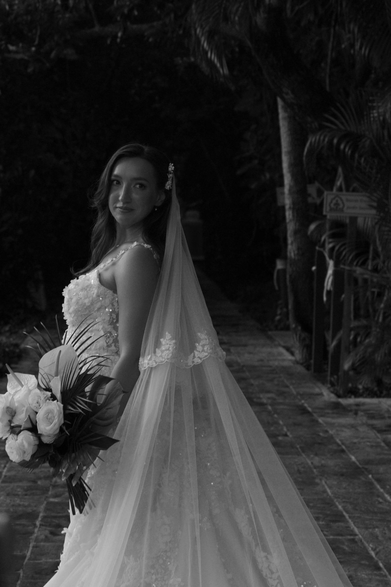 Dramatic black and white bridal portraits showing intricate lace details and flowing veil.