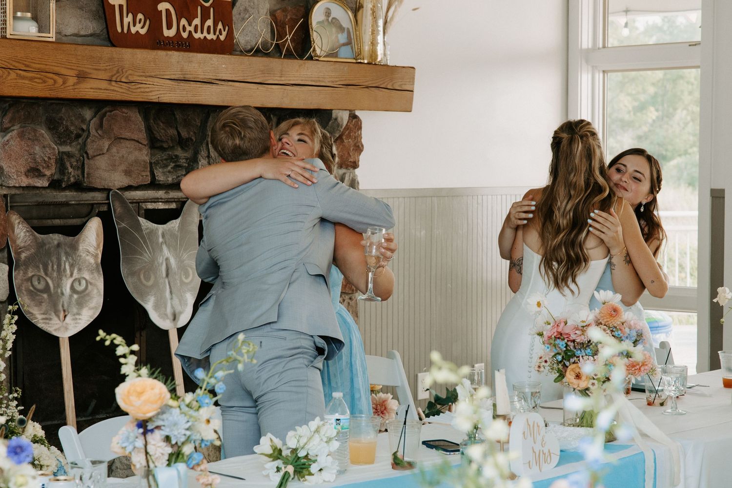 Wedding reception decor with blue and white table settings in an indoor venue.