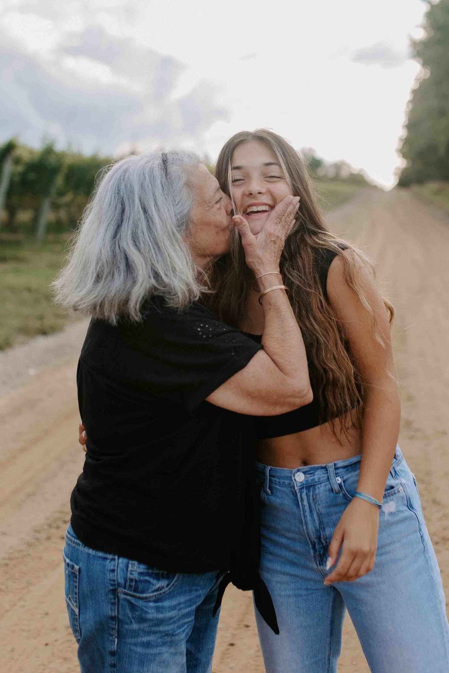 Sweet candid interaction between two people on a country road.