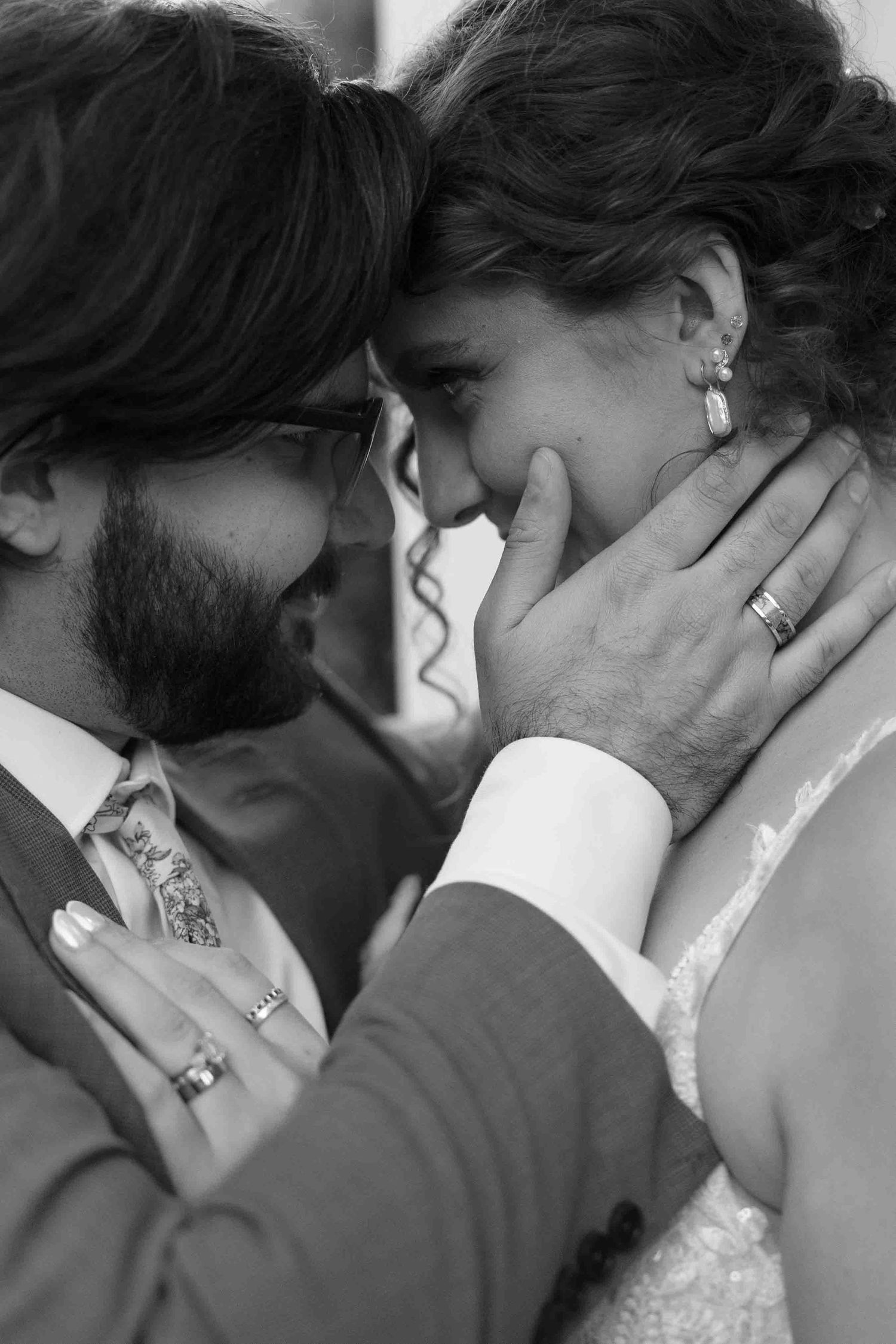 Black and white series of intimate close-up shots showing tender wedding moments.